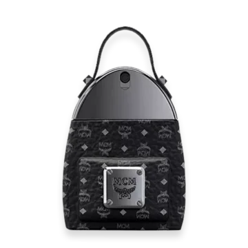 Black MCM-patterned backpack with a front zip pocket and a silver logo plaque, top handle, and a curved metallic top panel.