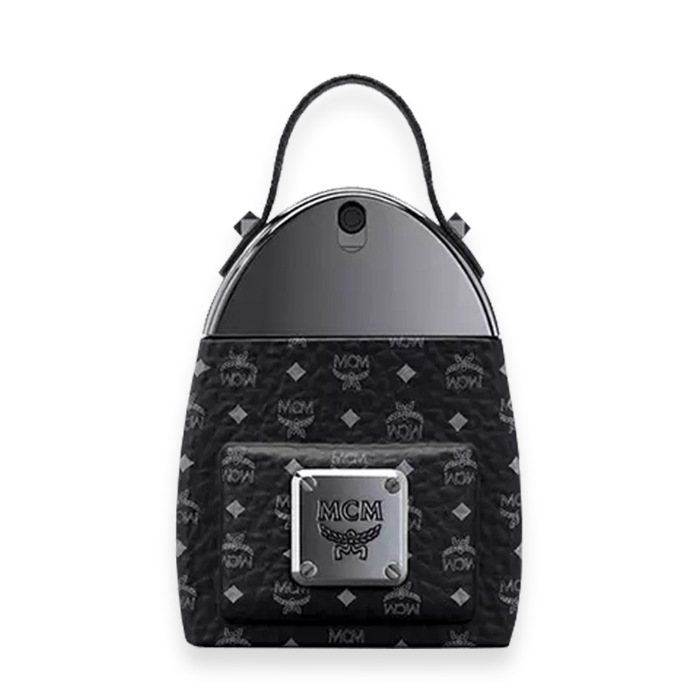 MCM Onyx Eau de Parfum » Scott Beauty Shop Black MCM-patterned backpack with a front zip pocket and a silver logo plaque, top handle, and a curved metallic top panel.