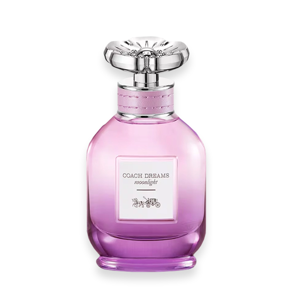 Dreams Moonlight » Scott Beauty Shop Pink gradient perfume bottle with a large ornate silver cap and a pink strap around the neck; label reads 'Coach Dreams moonlight'.