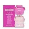 Pink Moschino Toy 2 Bubble Gum Eau de Toilette bottle in a bear shape beside a matching bright pink box, 30 ml.