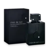 Black rectangular perfume bottle with a square cap and a hanging round pendant, placed next to a dark matching box labeled 'club de nuit intense man'.