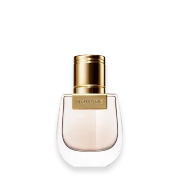 Nomade perfume bottle with a gold cap and light pink liquid in a curved glass flask