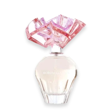 Perfume bottle with a faceted pink crystal cap and pale pink liquid, brand text visible on the bottle.