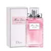 Bottle of Miss Dior Rose N’Roses perfume featuring a clear glass design with a silver bow and soft pink liquid.