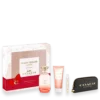 Coach Dreams Sunset gift set including pink perfume bottle, lotion, rollerball, mini spray, and a black COACH pouch with gold lettering